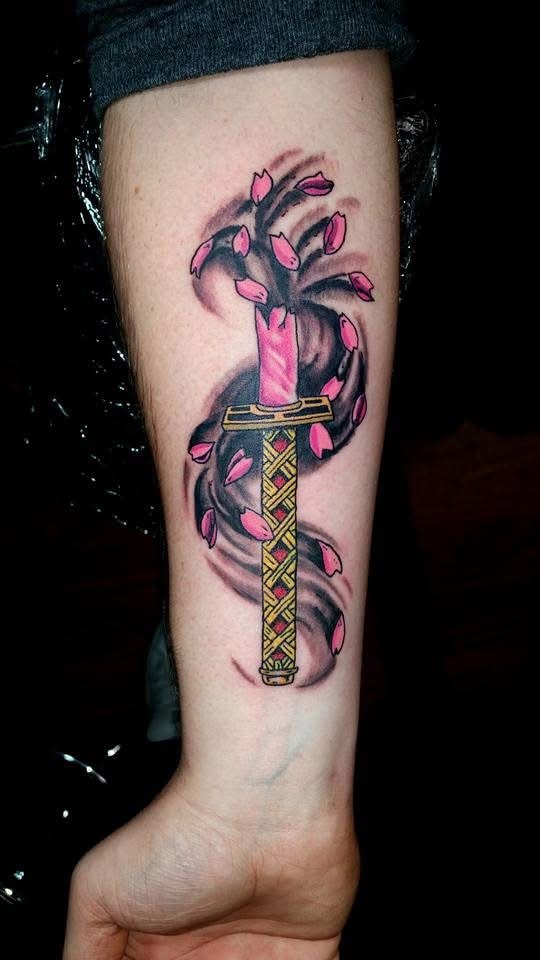 Japanese katana with cherry blossom petals and dark swirl forearm tattoo