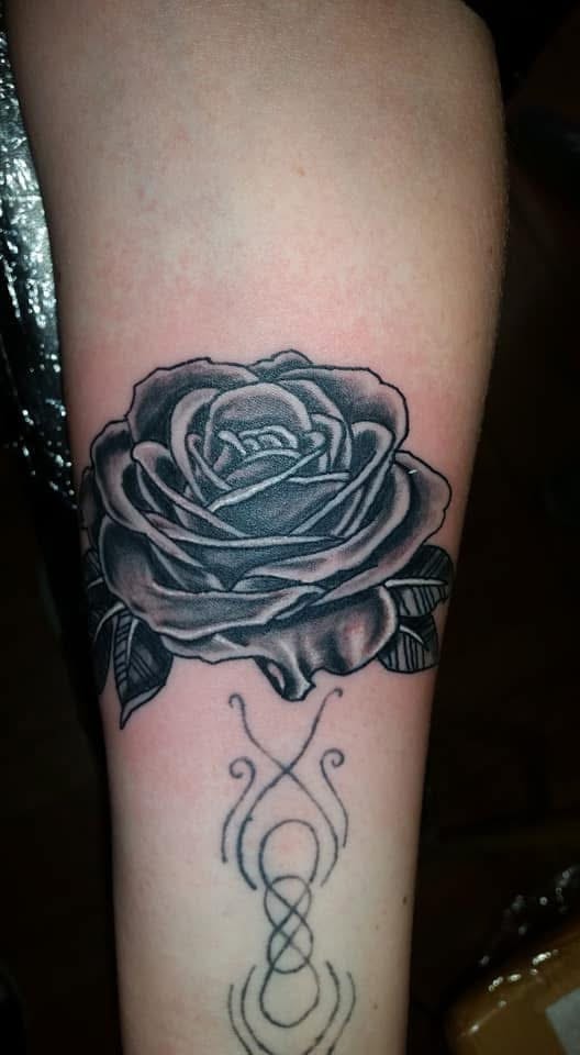 Black and grey rose with infinity tribal symbol forearm tattoo