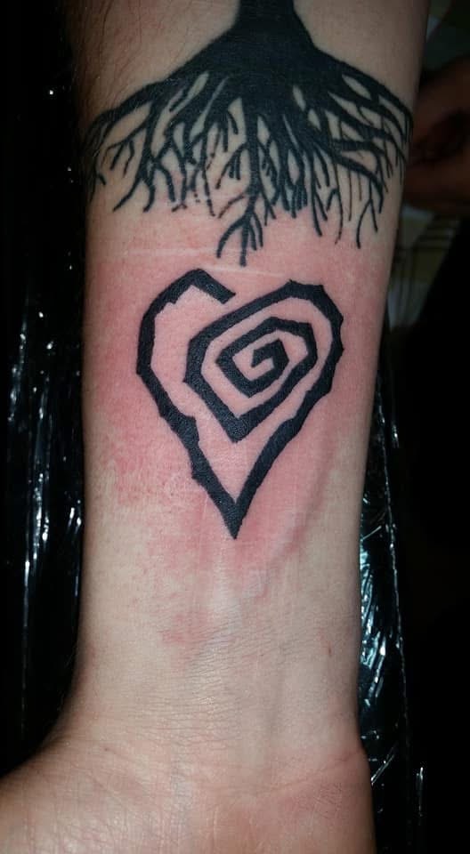 Tree roots on wrist with spiral heart blackwork tattoo