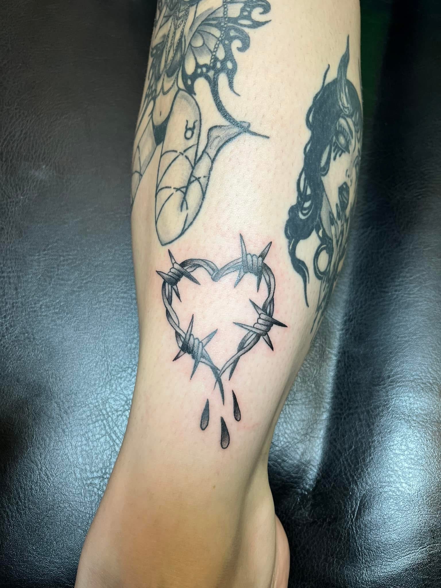 Barbed wire heart with dripping blood drops leg tattoo