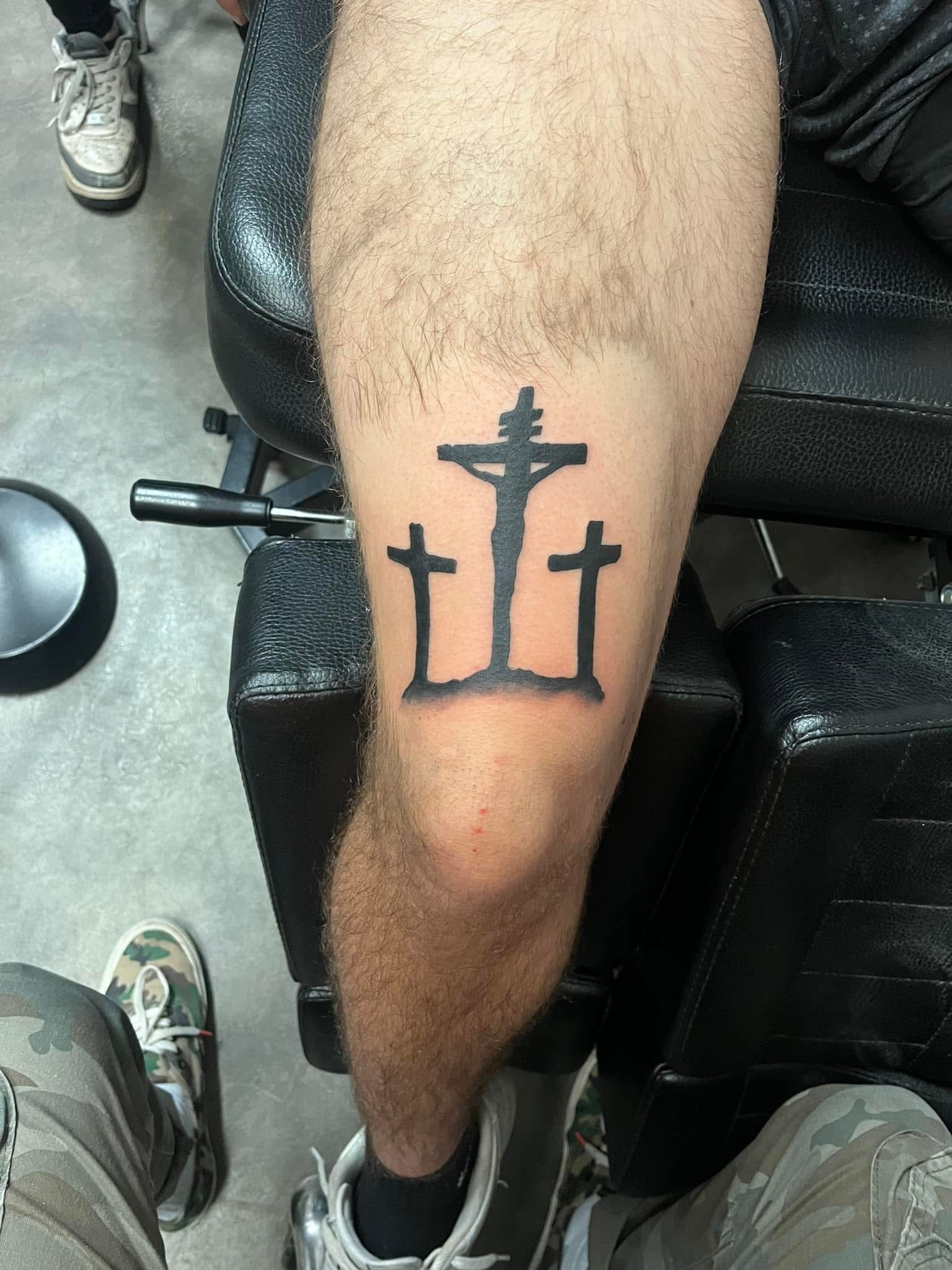 Three crosses crucifixion silhouette leg tattoo