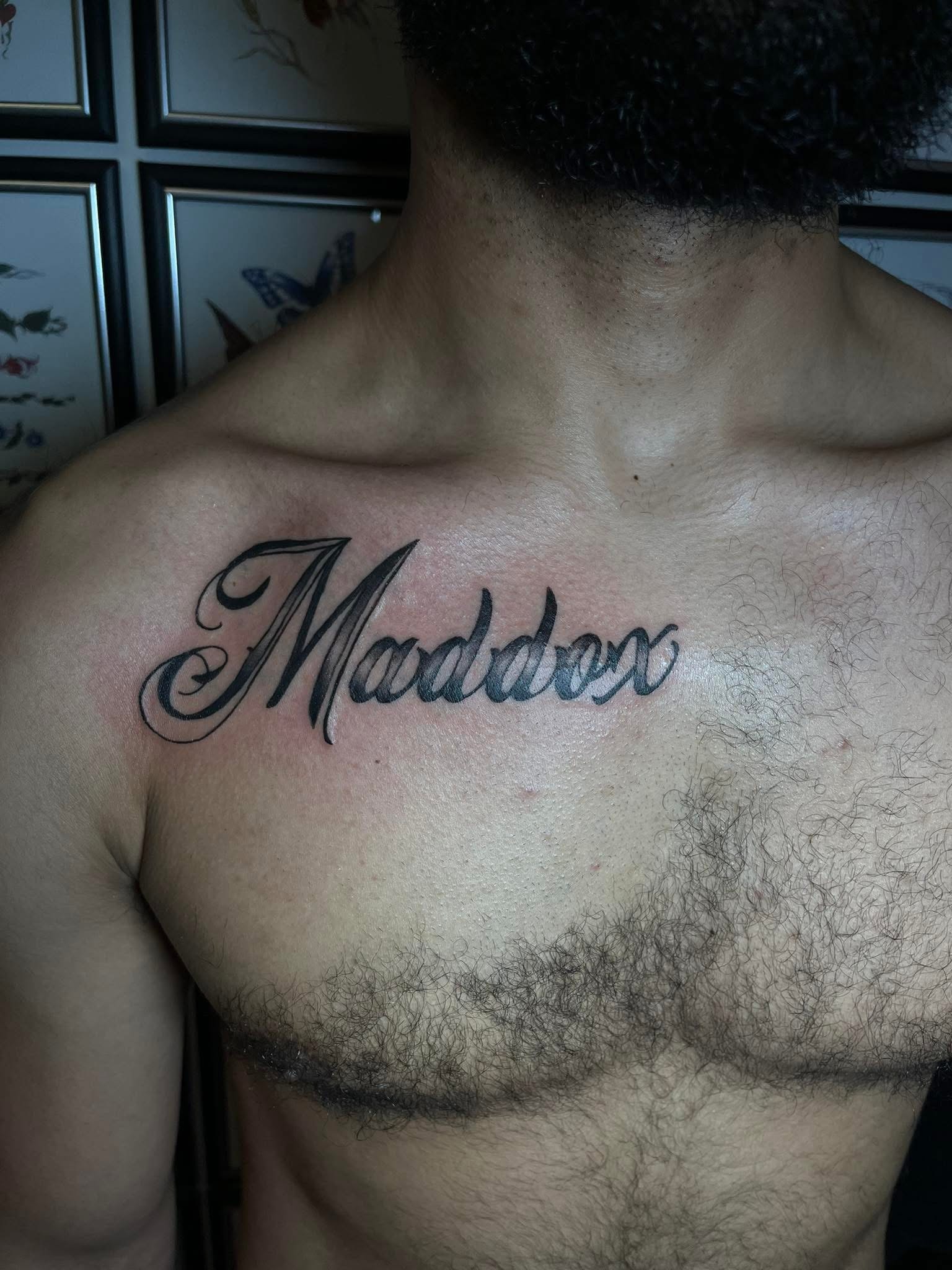 Maddox script lettering chest tattoo