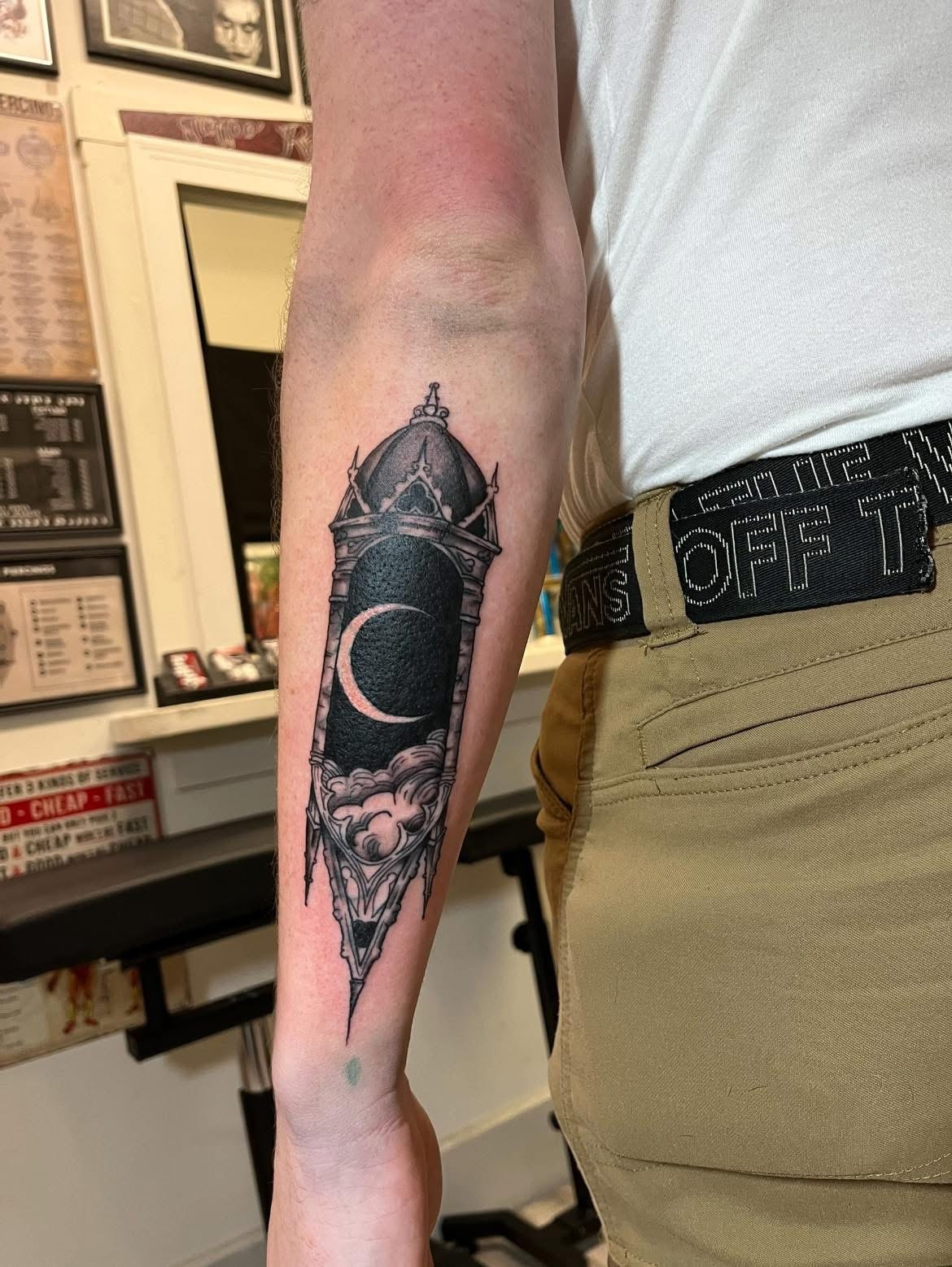 Gothic crescent moon arch with clouds forearm tattoo