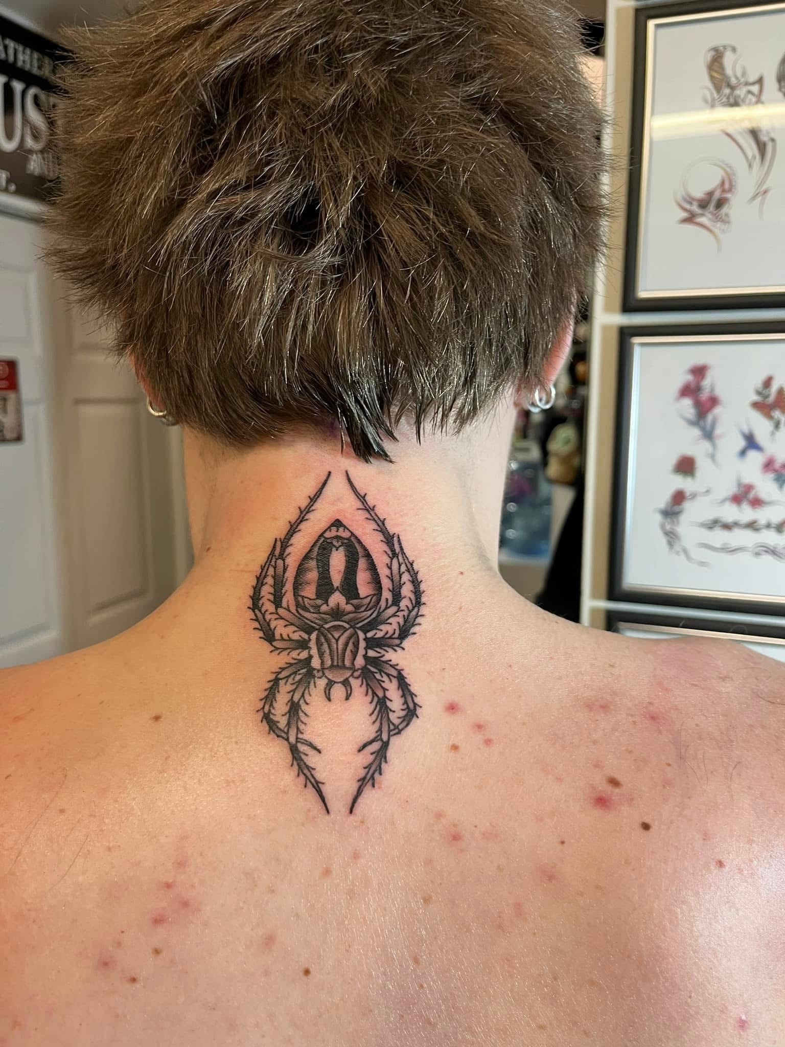 Ornate decorative spider neck tattoo