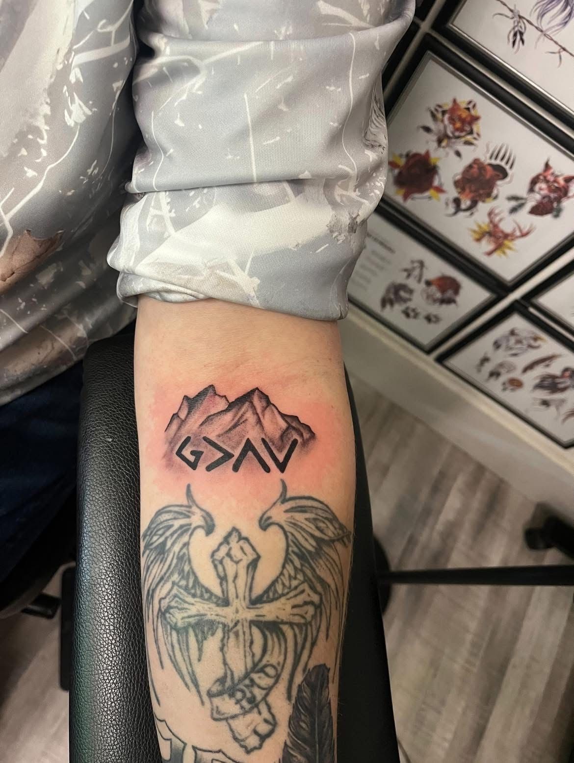 G greater than AV mountain peaks forearm tattoo