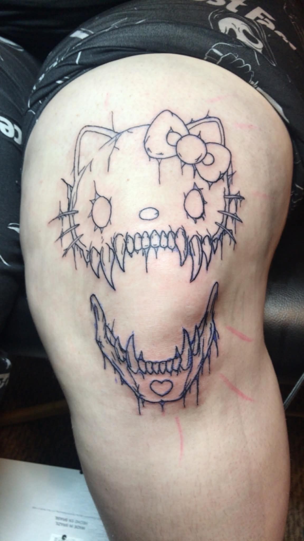 Creepy Hello Kitty skull thigh tattoo
