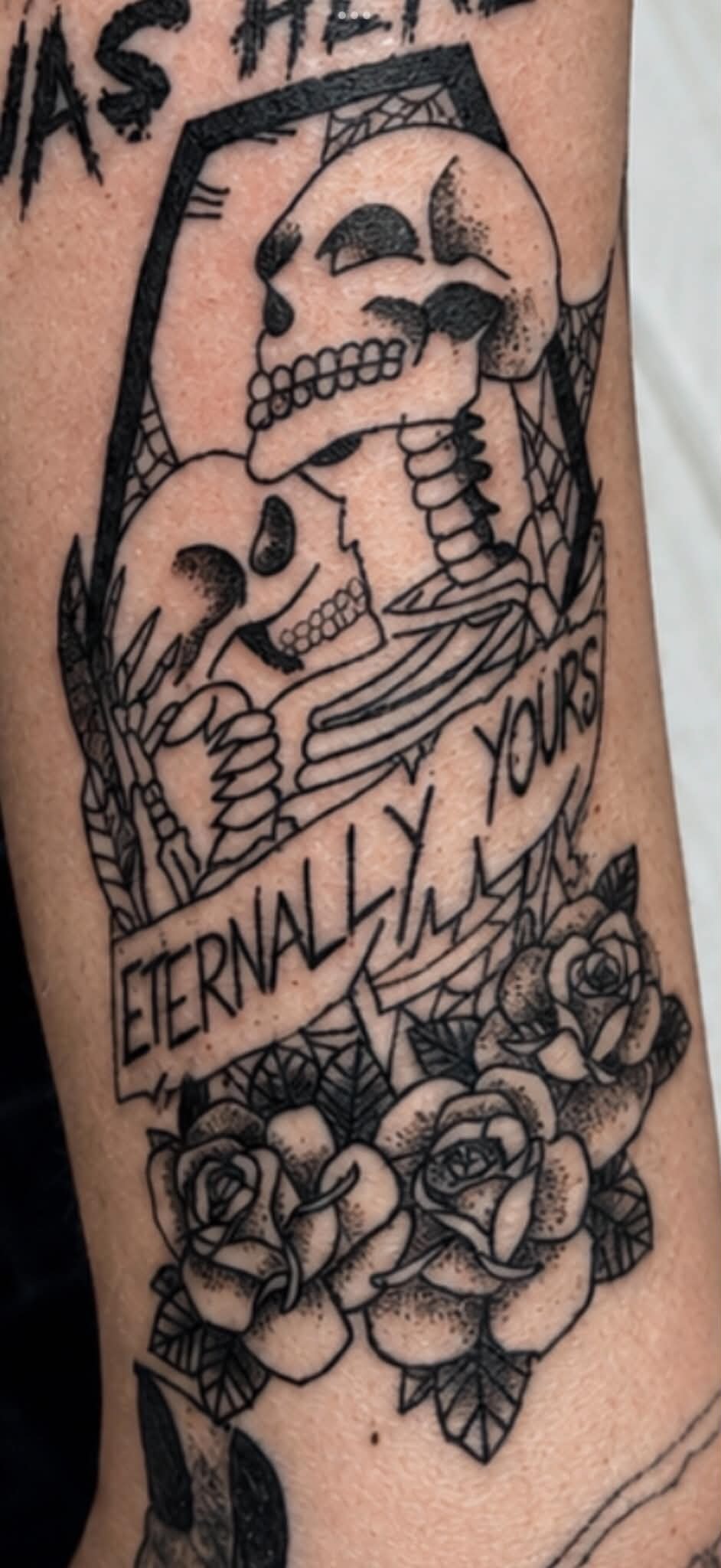 Eternally Yours skeleton couple with roses arm tattoo