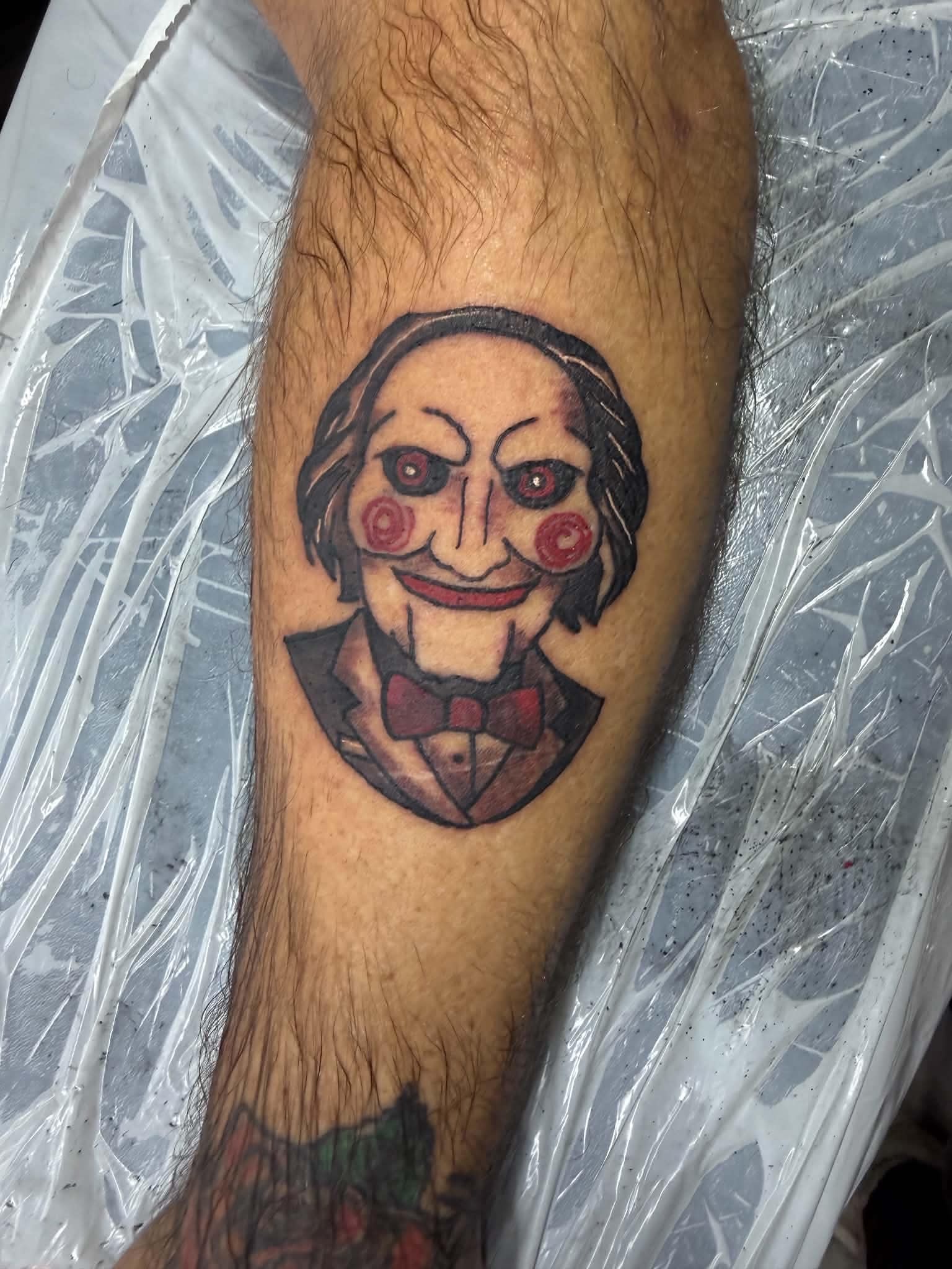 Billy the Puppet Saw horror character arm tattoo
