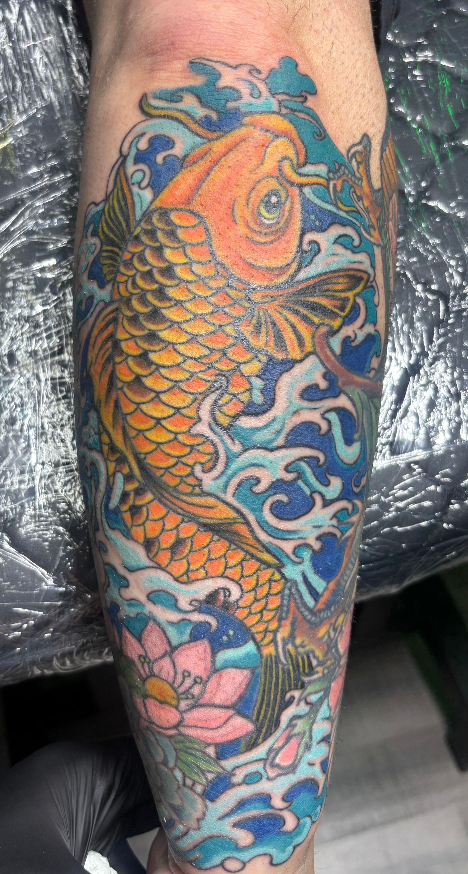 Randy DeShong colorful koi fish tattoo