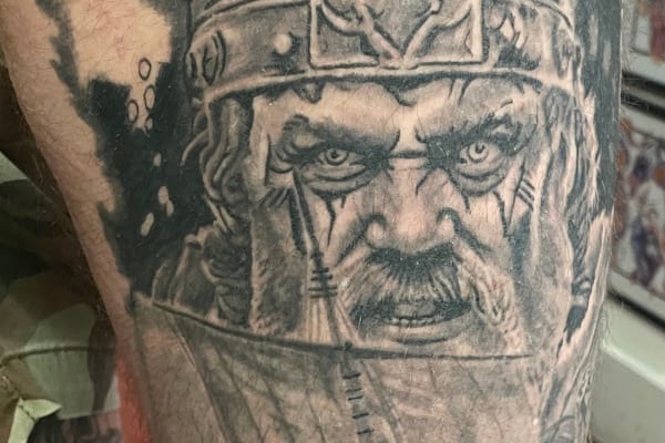 Stacked demon faces black ink tattoo