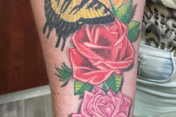 Butterfly and roses colorful arm tattoo